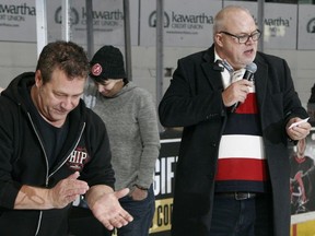 Longtime TV personality and current radio personality Bill Welychka celebrates as Kinsmen Club of Kingston Dream Home chair Graham Forsythe, right, reads the name of the Dream Home winner during the first intermission of the Kingston Frontenacs' Ontario Hockey League game against the Mississauga Steelheads on Friday, Jan. 5.