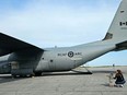 Anna Down of Kingston kneels as her two-year-old son points in awe at a massive CC-130H Hercules aircraft, flown in from Canadian Forces Base Trenton in September as part of the City of Kingston and CFB Kingston's Wheels on the Runway event in support of the United Way of Kingston, Frontenac, Lennox and Addington campaign.