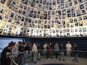 Visitors tour the Hall of Names at Yad Vashem