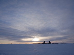 Pair of grain elevators on a snow covered field