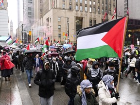 Demonstrators shout slogans in protest of Israel's continued attacks on the Gaza Strip, in downtown Toronto, Saturday, Dec. 23, 2023.