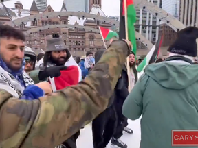 Protesters clash with a senior skating at Nathan Phillips Square in a screenshot from video.