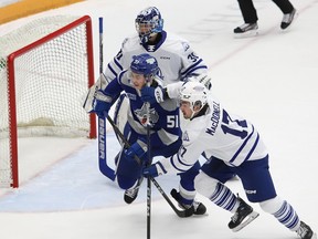 Dalibor Dvorsky, left, of the Sudbury Wolves, and Angus MacDonell, of the Mississauga Steelheads, battle for position in front of Steelheads goalie Ryerson Leenders during OHL action at the Sudbury Community Arena in Sudbury, Ont. on Wednesday January 10, 2024.