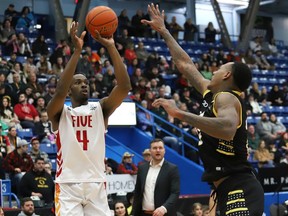 Jalen Hayes, left, of the Sudbury Five, shots over Billy White, of the London Lightning, during basketball action at the Sudbury Community Arena in Sudbury, Ont. on Friday January 12, 2024.