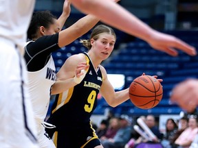 Lauren Robertson-Martin of the Laurentian Voyageurs looks for an opening through Western Mustangs players during OUA basketball action from the Sudbury Community Arena on Saturday.
