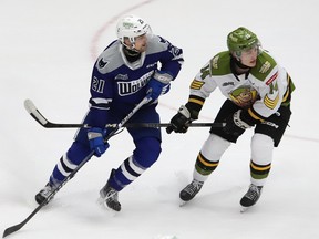 Alex Pharand, left, of the Sudbury Wolves, and Dalyn Wakely, of the North Bay Battalion, battle for position during OHL action at the Sudbury Community Arena in Sudbury, Ont. on Friday January 26, 2024.