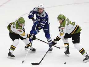 Quentin Musty, middle, of the Sudbury Wolves, battles for possession of the puck with Paul Christopoulos and Tnias Mathurin, of the North Bay Battalion, during OHL action at the Sudbury Community Arena in Sudbury, Ont. on Friday January 26, 2024.