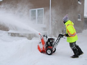 Kevin Berlingeri clears snow from his driveway