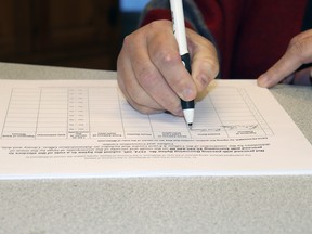 A person signs a petition against a Town of Whitecourt borrowing bylaw to build a regional Culture and Events Centre.