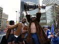 Winnipeg Blue Bombers quarterback Chris Streveler hoists the Grey Cup at Portage and Main during a parade on Tues., Nov. 26, 2019.