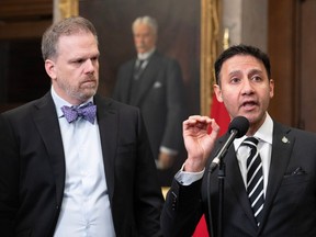 Federal Health Minister Mark Holland, left, and Justice Minister Arif Virani discuss their legislation to delay the expansion of medically assisted death. They spoke on Thursday, Feb. 1, 2024 in Ottawa.