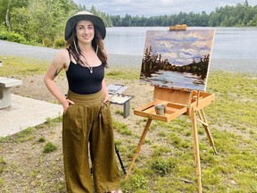 Marie Osmun, one of Fredericton's 2023 artists-in-residence, works on a painting at Killarney Lake Park. The city is offering the artist-in-residence program again this year at Killarney Lake and the Fredericton Botanic Garden.