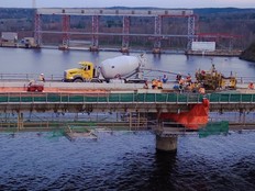 Crews pour concrete on a section of the deck of the Mactaquac approach channel bridge last year. DTI says the bridge will still be reduced to one lane this year, with periodic three-day closures planned for concrete pouring work.