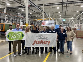 The Jokey team holds a sign showing the company's logo.