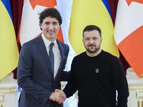 In this handout photograph taken and released by Ukrainian Presidential Press Service on February 24, 2024, Ukraine's President Volodymyr Zelensky (R) shakes hands with Canada's Prime Minister Justin Trudeau (L) during a signing ceremony following their talks in Kyiv, on the second anniversary of the Russian invasion of Ukraine.