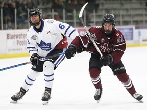 Chatham Maroons' Colton Henderson (97) and London Nationals' Brandon Scott (6) chase the puck at Chatham Memorial Arena in Chatham, Ont., on Sunday, Jan. 21, 2024. Mark Malone/Chatham Daily News/Postmedia Network
