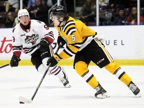 Sarnia Sting's Mitch Young (5) is watched by Guelph Storm's Parker Snelgrove (9) in the second period at Progressive Auto Sales Arena in Sarnia, Ont., on Saturday, Feb. 10, 2024. Mark Malone/Chatham Daily News/Postmedia Network