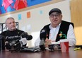 Two men at press conference table