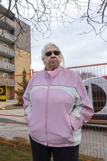 Displaced from her apartment by a fire at a Tillsonburg building in March 2022, Yvonne Steffler surveys the building site on Lisgar Avenue in December 2023. Steffler has been living nearby, with her sister, but wants to return to the building where she lived for four years, paying what she considered reasonable rent.  Photograph taken on Wednesday December 6, 2023. Mike Hensen/The London Free Press/Postmedia Network
