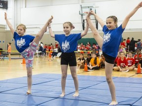 Ava Knox, 9, Ella Barlow, 10, and Synnova Caldwell, 9, from the Oxford School, an independent school near Woodstock, perform a mat routine at the London District Catholic school board's elementary gymnastics meet at Carling Heights Optimist community centre in London on Monday, Feb. 26, 2024. (Mike Hensen/The London Free Press)