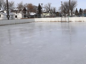An outdoor skating rink in a city neighbourhood