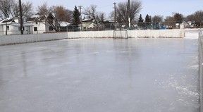 An outdoor skating rink in a city neighbourhood