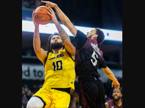 Jermaine Haley of the London Lightning gets stuffed by Trendon Hankerson of the Windsor Express, who was called for a foul, during their Basketball Super League game at Budweiser Gardens in London on Sunday February 4, 2024. Mike Hensen/The London Free Press
