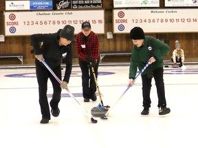 Chatham Granite Club coach Anita Quenneville helps Julie-Ann Daley, left, and Callum Park, 11, practise sweeping before the second Family Day Funspiel at the Chatham Granite Club Monday. (Ellwood Shreve/Chatham Dailyn News)