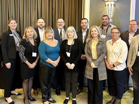 Chatham-Kent Mayor Darrin Canniff, centre rear, and Ontario Real Estate Association CEO Tim Hudak, third right rear, join a large Chatham-Kent Association of Realtors members at the Western Ontario Housing Economic Summit in London last Friday. (Supplied)
