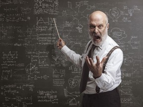 Stock photo of angry man pointing at chalkboard