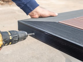 Stock photo of someone installing composite decking