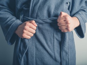 Closeup stock photo of person tightening belt on a housecoat