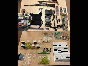 Illegal substances, firearms and weapons seized by Kingston Police during a search of a residence on Grey Street in Kingston, Ont., on Wednesday, January 31, 2024.