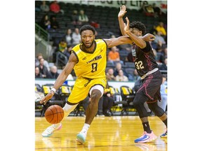 Rashad Smith of the London Lightning gets around Latin Davis of the Windsor Express at Budweiser Gardens in London on Wednesday, Jan. 24, 2024. (Mike Hensen/The London Free Press)