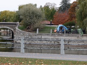A homeless person sets up a tent on NCC property on the Rideau Canal near Patterson Creek in November, 2023.