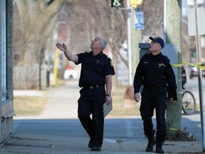 Pete Aalbers, a Sarnia fire prevention officer, points something out to Ontario Fire Marshal investigator Jim Kettles during a probe Tuesday of a fire that broke out the previous night inside a building at the corner of Mitton and George streets. (Terry Bridge/Sarnia Observer)