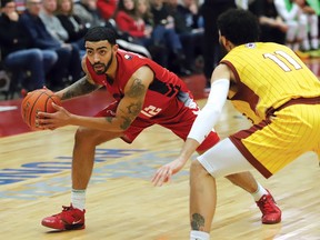 Landon Kirkwood, left, of the Sudbury Five, looks for a clear lane to drive against Robert Hobson, of the Newfoundland Rogues, during basketball action at the Sudbury Community Arena in Sudbury, Ont. on Friday February 2, 2024.