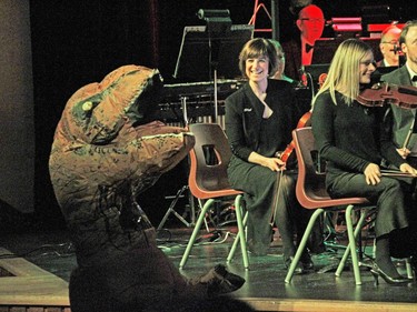 LouAnn Visconti watches a Jurassic Park Velociraptor at the TSO's movie music concert