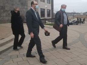 Justin David Breau, centre, is seen leaving Saint John Law Courts in 2020