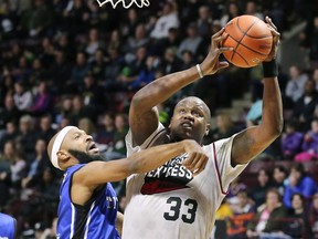Dexter Williams Jr., left, of the KW Titans and Paul Harrison of the Windsor Express battle for a rebound at the WFCU Centre in Windsor on Monday, February 19, 2024