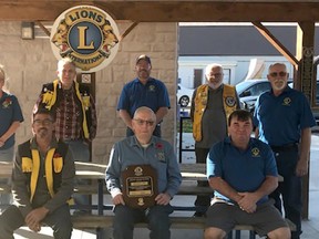 Zurich Lions Club members sit together.