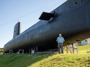 Ian Raven stands in front of the newly painted HMCS Ojibwa in Port Burwell in this file photo. (Free Press files)