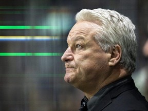 London Knights head coach Dale Hunter watches the tribute to his 908 Ontario Hockey League wins at the start of their game against the Brantford Bulldogs in London on Friday November 3, 2023. (Mike Hensen/The London Free Press)