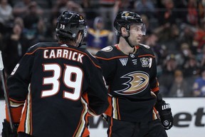 Anaheim Ducks center Adam Henrique, right, celebrates his goal against the Buffalo Sabres with center Sam Carrick during the third period of an NHL hockey game Tuesday, Jan. 23, 2024, in Anaheim, Calif. THE CANADIAN PRESS/AP, Ryan Sun