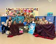 Students at Southpointe School show off their blanket creations and gathered donations.