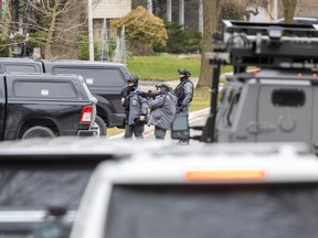 London police officers surround a home at 48 Kinnear Cres. in London on Tuesday March 19, 2024. (Derek Ruttan/The London Free Press)