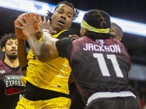 Amir Yusuf of the London Lightning is surrounded by Tyler Groce, Paul Harrison and Ja'Myrin Jackson of the Windsor Express during their Basketball Super League game in London on Sunday February 4, 2024. (Mike Hensen/The London Free Press)