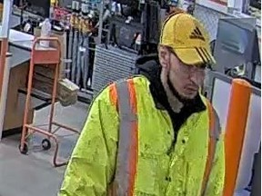 The suspect is described as having a pale complexion, male, at least six feet tall, slender, having a short cropped beard and facial hair, and was last seen wearing blue jeans, prescription glasses, a yellow Adidas hat, and a yellow and orange safety jacket.