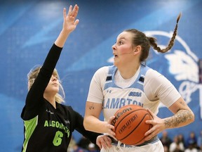 Lambton Lions' Avery Bathe-Minard (8) is defended by Algonquin Wolves' Sydney Moore (6) during the OCAA women's basketball final at Lambton College in Sarnia, Ont., on Sunday, March 3, 2024. Mark Malone/Chatham Daily News/Postmedia Network