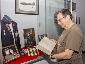 Military museum chair looks at a pilot's logbook